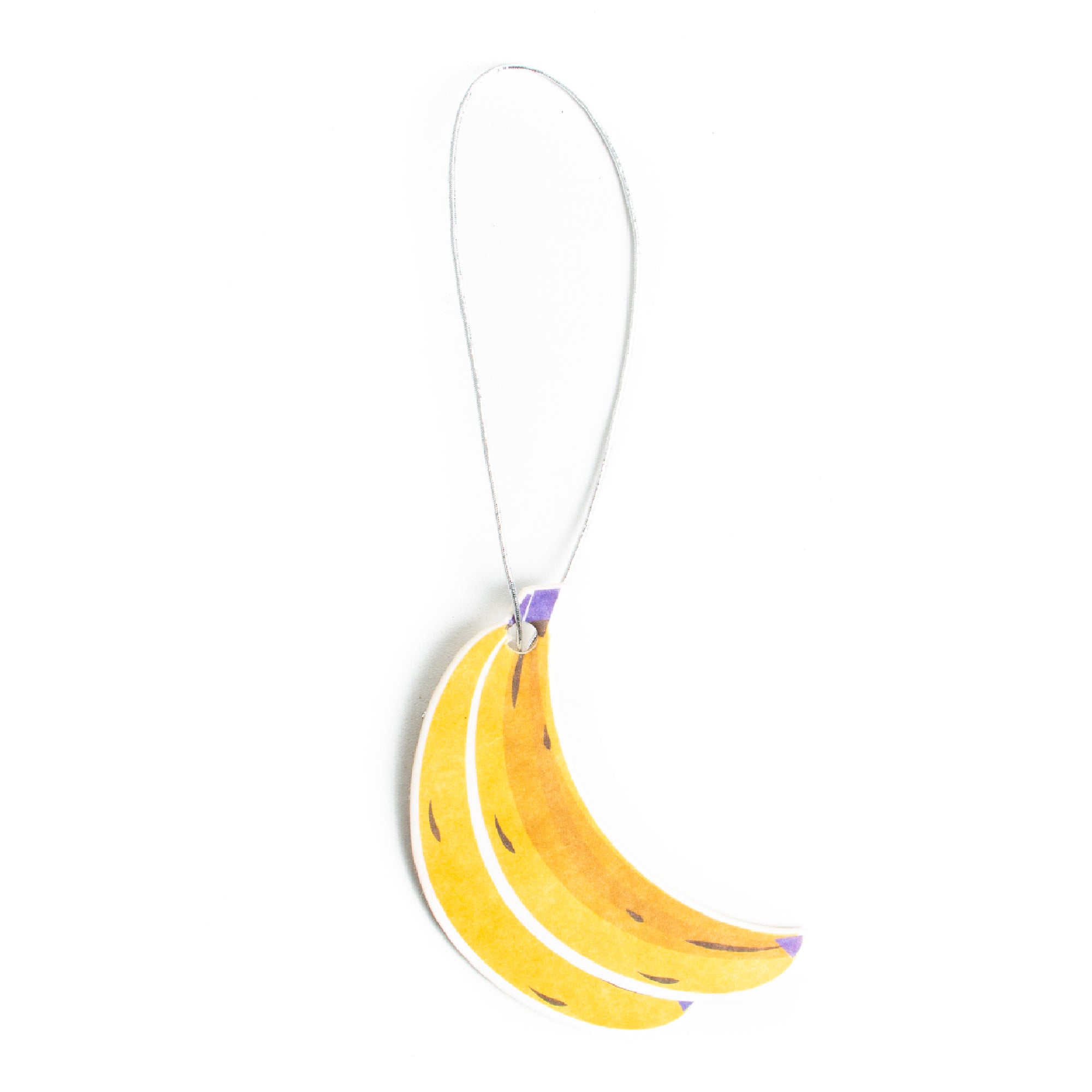 A banana-shaped air freshener with a yellow and green design, hanging on a string.