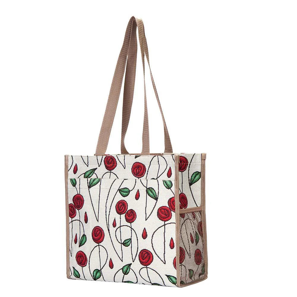 A large tote bag with a floral-inspired pattern, featuring deep red roses and green leaves on a white background, with two beige handles.