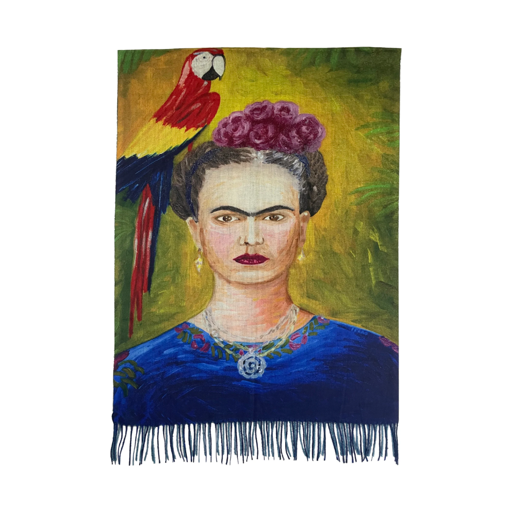 A scarf featuring a portrait of Frida Kahlo with a colorful parrot and floral design, and a tassel at the bottom.