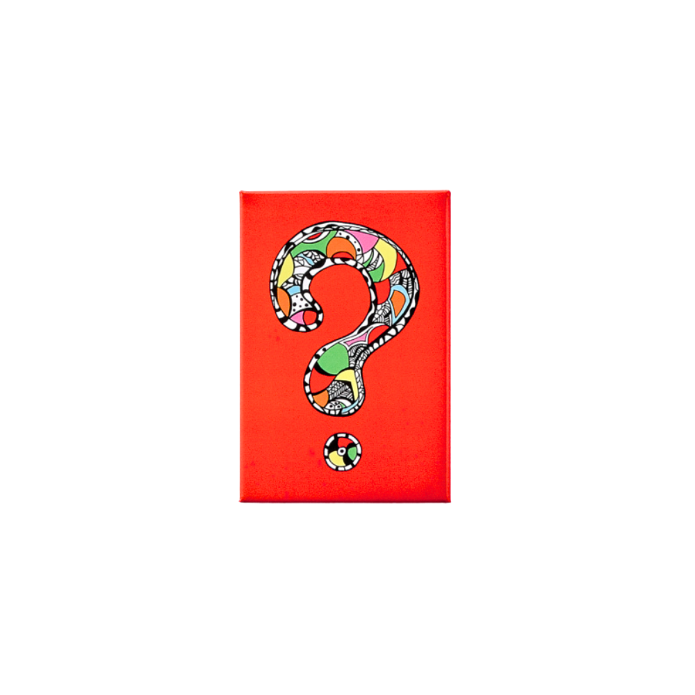 A rectangular magnet with a multicolored question mark design and a small circular logo at the bottom.
