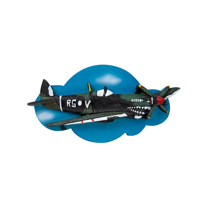 A resin magnet in the shape of a vintage spitfire aircraft displayed on a blue magnetic mount.