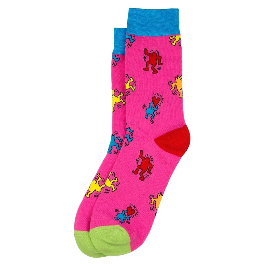 A pair of pink and blue socks with colorful, geometric patterns inspired by Keith Haring's artwork.
