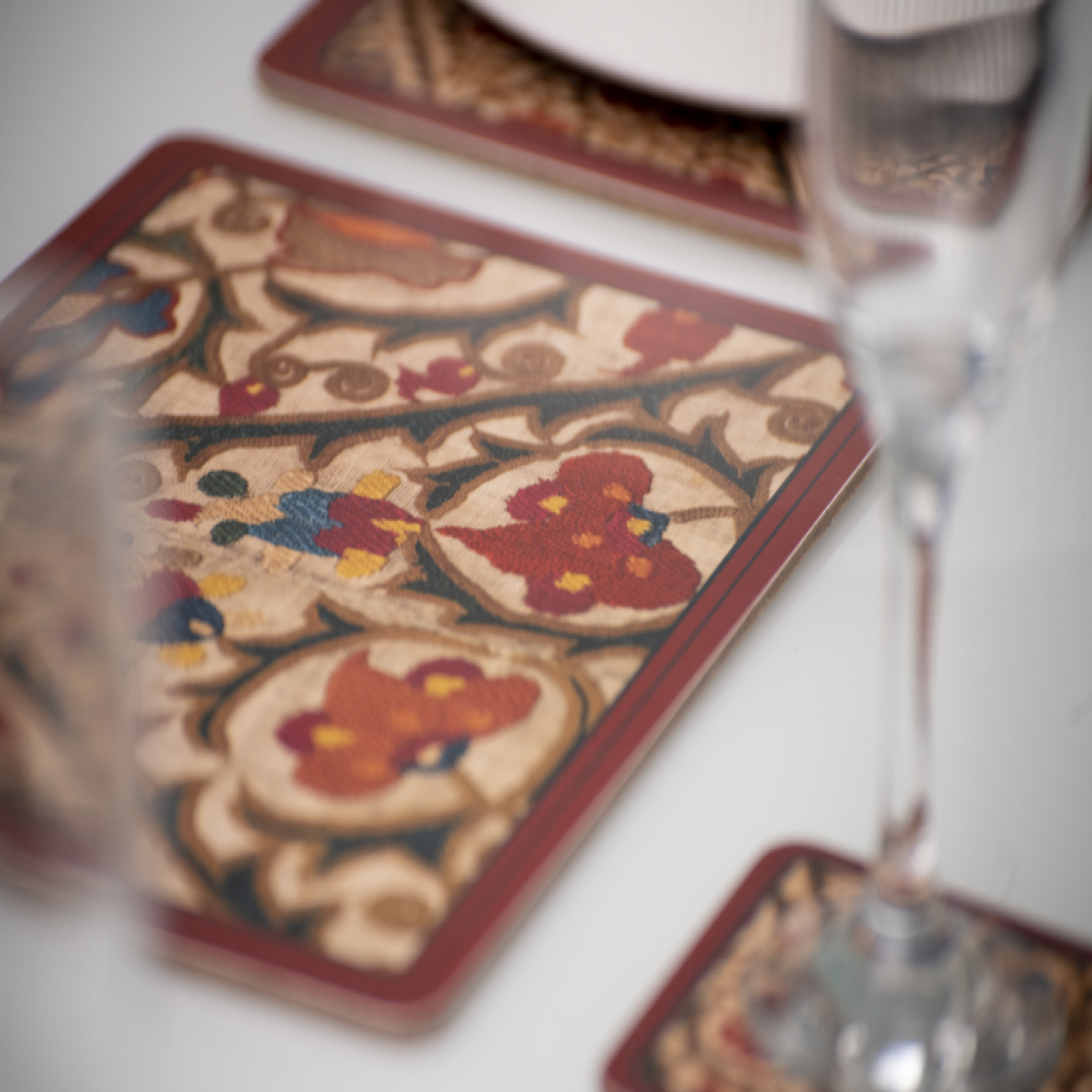 Decorative coasters with intricate designs on a table.